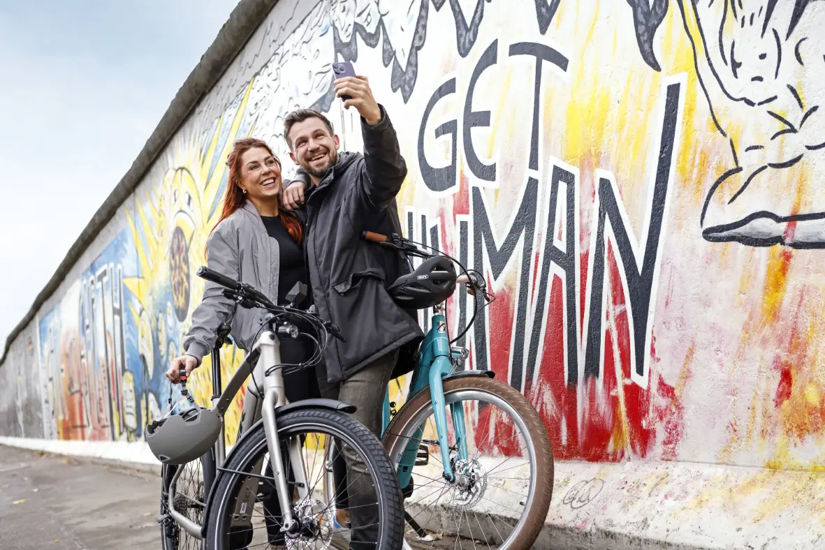 Frau mit Fahrrad auf dem Weg zur Arbeit – Bikeleasing